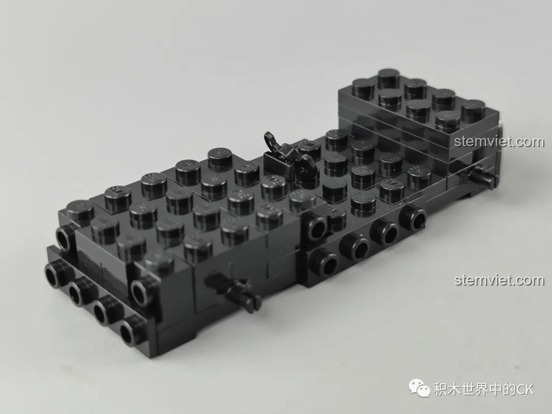 Phần đế của mô hình xe đua Tôn Ngộ Không Enlighten 74021 đang được lắp ráp, cho thấy cấu trúc cơ bản của xe.