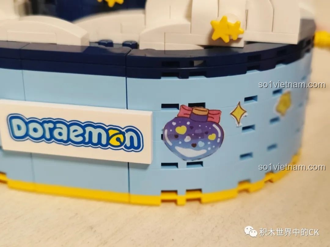 Phụ kiện treo hình đám mây và ngôi sao được gắn vào phi thuyền của Keeppley K20421 Doraemon, tăng tính trang trí và vui nhộn.