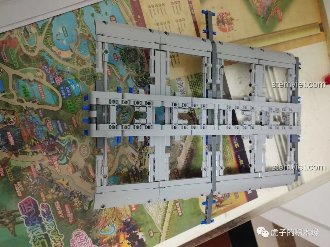 Khung gầm xe tải cần cẩu khí nén Mould King 19002 đang được lắp ráp, cho thấy sự phức tạp của hệ thống treo và truyền động. Review Mould King 19002.