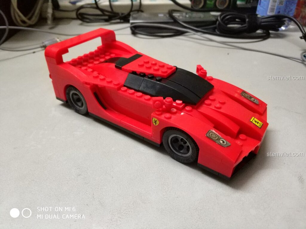 Chiếc xe đua Ferrari F40 Roadster màu đỏ được lắp ráp từ bộ QMAN 404, thể hiện sự mạnh mẽ và tốc độ.