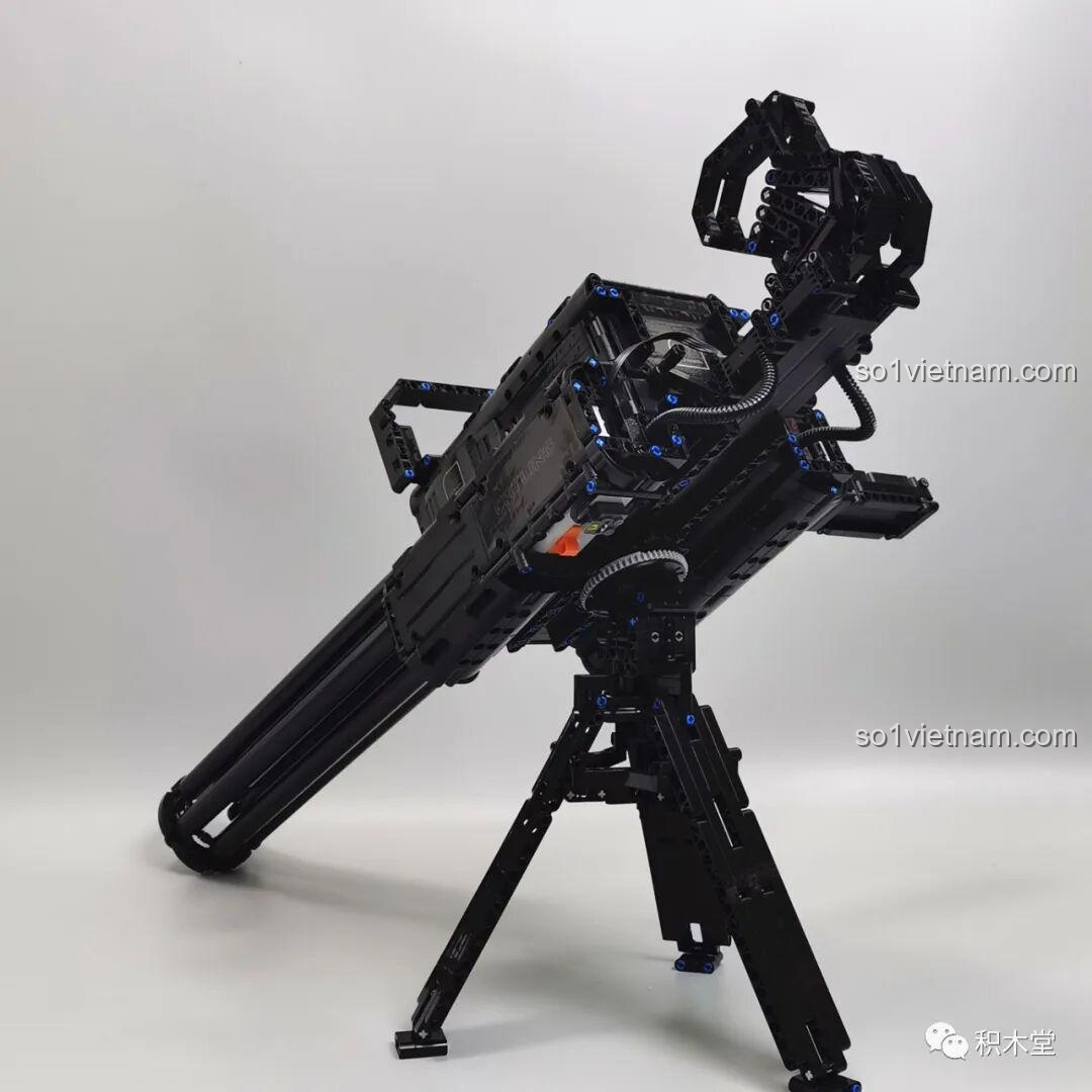 Mô hình súng Gatling Taigao Le T2036 đã lắp ráp hoàn chỉnh, đặt trên chân đế tripod, góc nhìn nghiêng từ phía sau, cho thấy các chi tiết cơ khí và thiết kế tổng thể của đồ chơi lắp ráp súng máy Gatling.