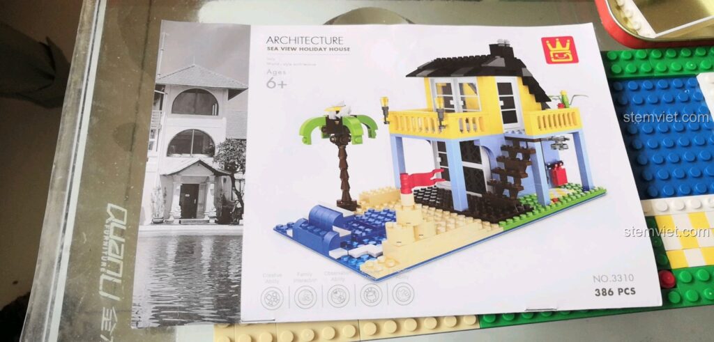 Hộp sản phẩm WANGE 3310 với hình ảnh căn nhà nghỉ dưỡng ven biển và thông tin chi tiết về bộ lắp ráp.