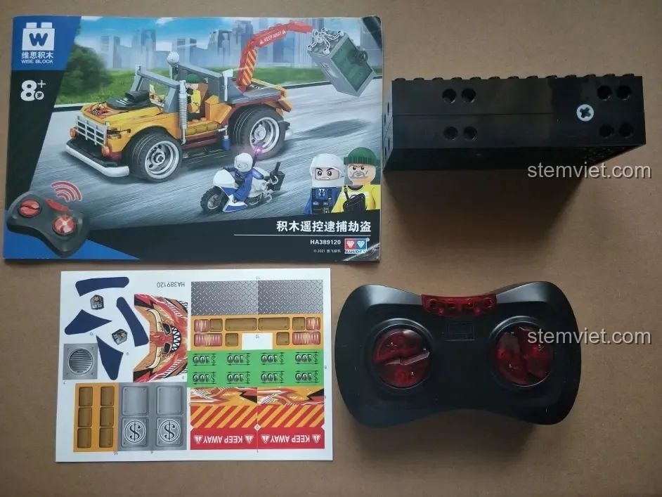 Toàn bộ nội dung bên trong bộ lắp ghép Xe Cảnh Sát Cứu Hộ Điều Khiển Từ Xa HA389120, bao gồm sách hướng dẫn, bộ điều khiển và khối đế.