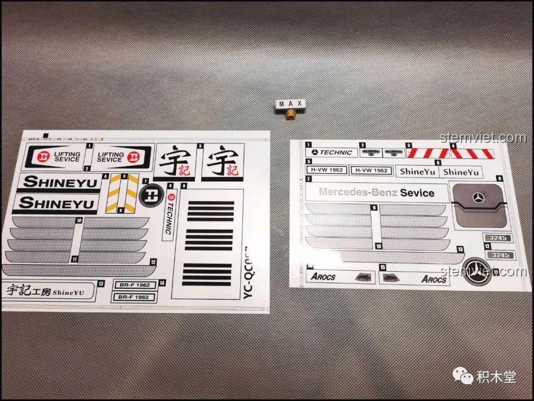 Hai tờ sticker với logo Mercedes-Benz và các chi tiết trang trí cho đồ chơi xếp hình Xe Tải Mercedes-Benz Actros YCQC007.