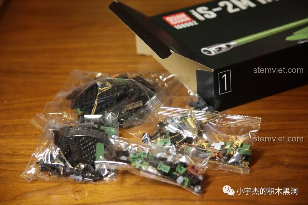 Hình ảnh các mảnh ghép được đổ ra từ túi trong hộp số 1 của bộ đồ chơi lắp ráp xe tăng hạng nặng IS-2M QUANGUAN 100062, giúp bé trai phát triển tư duy.