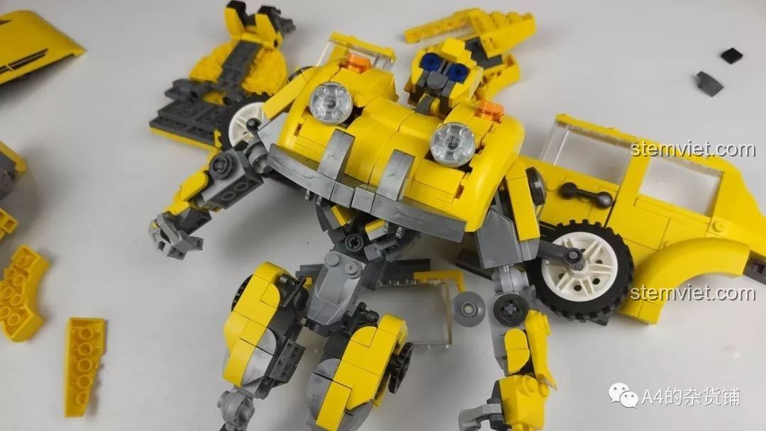 Mô hình Robot Đại Hoàng Phong Panlos Brick 621019 đứng vững giữa các mảnh ghép bị bung ra, thể hiện sự khó khăn trong quá trình biến hình và giữ tư thế.