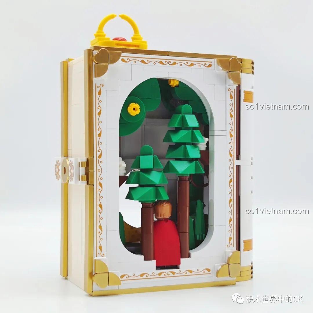 Mặt sau của sách mô hình cổ tích Bạch Tuyết Wekki, cho thấy khung cảnh khu rừng qua ô cửa sổ.