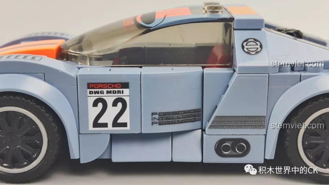 Cận cảnh phần đầu xe của mô hình xe đua màu xám cam Sembo 607050, với dải cam và đèn pha.