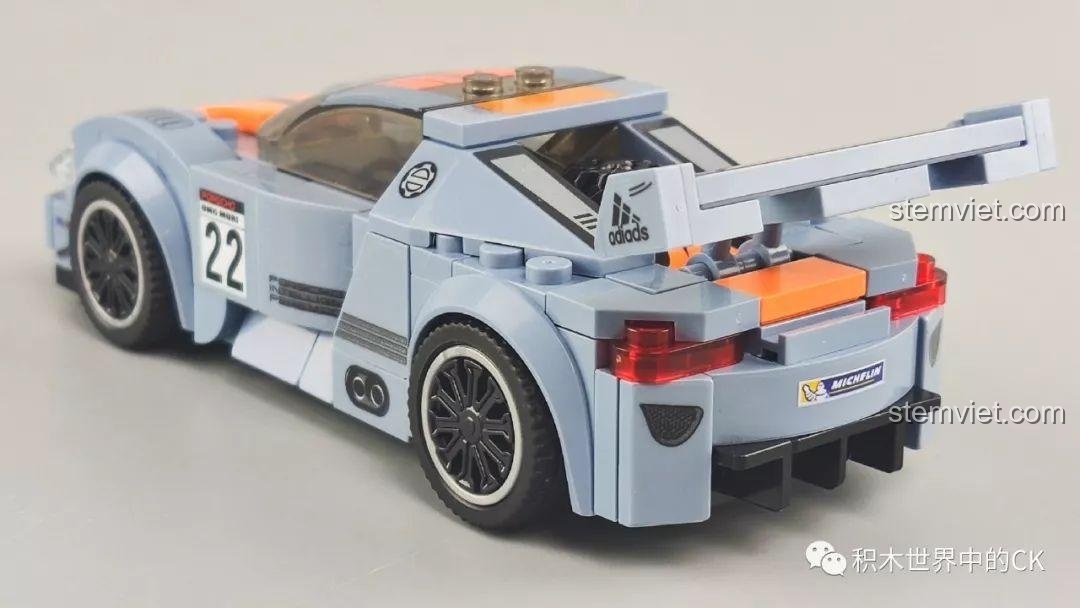 Góc nhìn 3/4 phía sau của mô hình xe đua màu xám cam Sembo 607050, với đèn hậu đỏ.