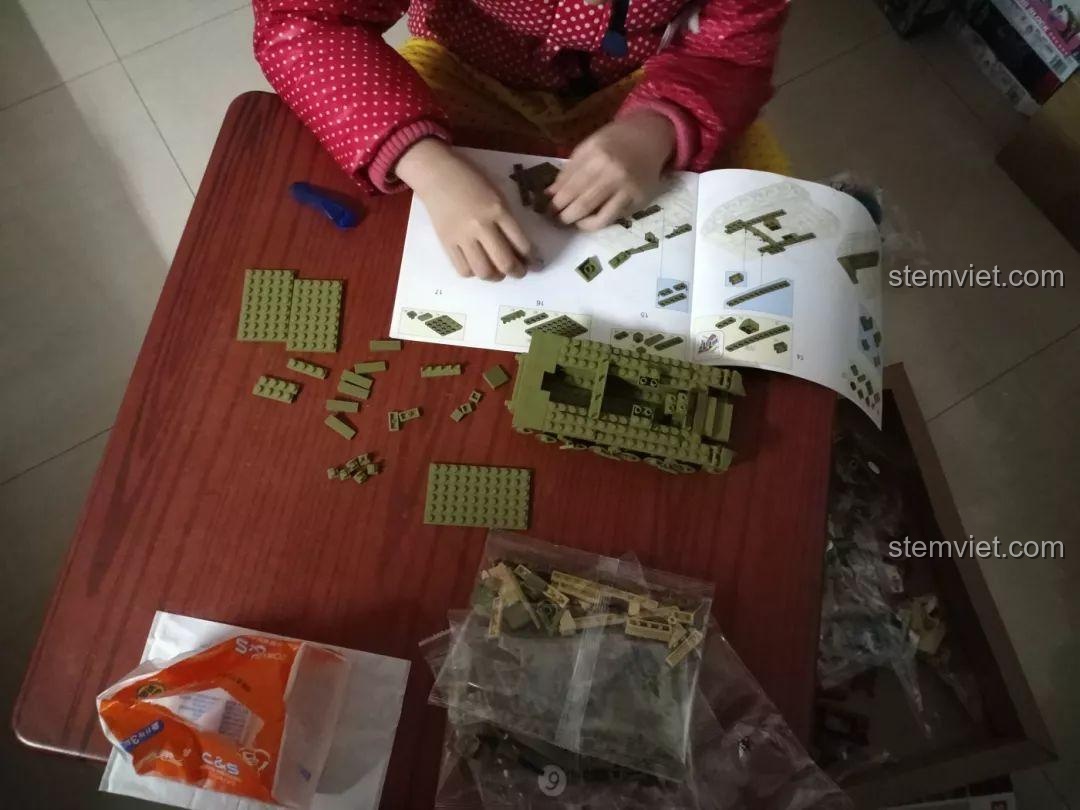 Bộ lắp ráp Mô hình xe tăng Thế chiến II, bé trai đang tập trung lắp ráp xe tăng, rèn luyện kỹ năng phối hợp tay mắt.