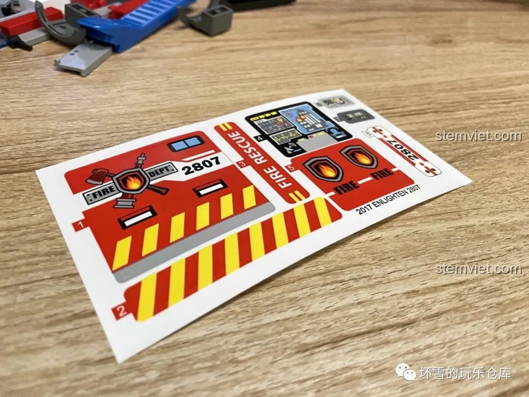 Tấm sticker đi kèm trong bộ QMAN 2807 với các chi tiết như logo, bảng điều khiển và số hiệu xe.