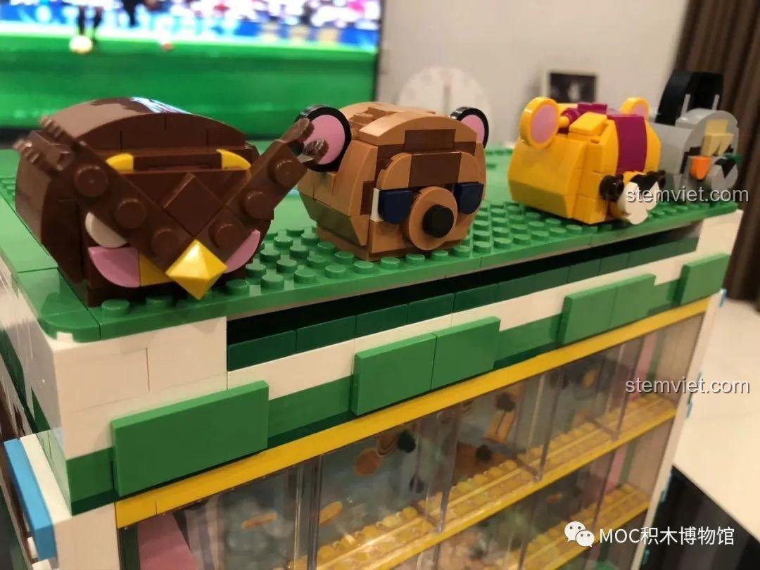 Chi tiết các đầu động vật trang trí trên đỉnh bộ lắp ghép Super 18K K104 Máy đẩy xu điện tử, đồ chơi mô hình Máy gắp xu điện tử.