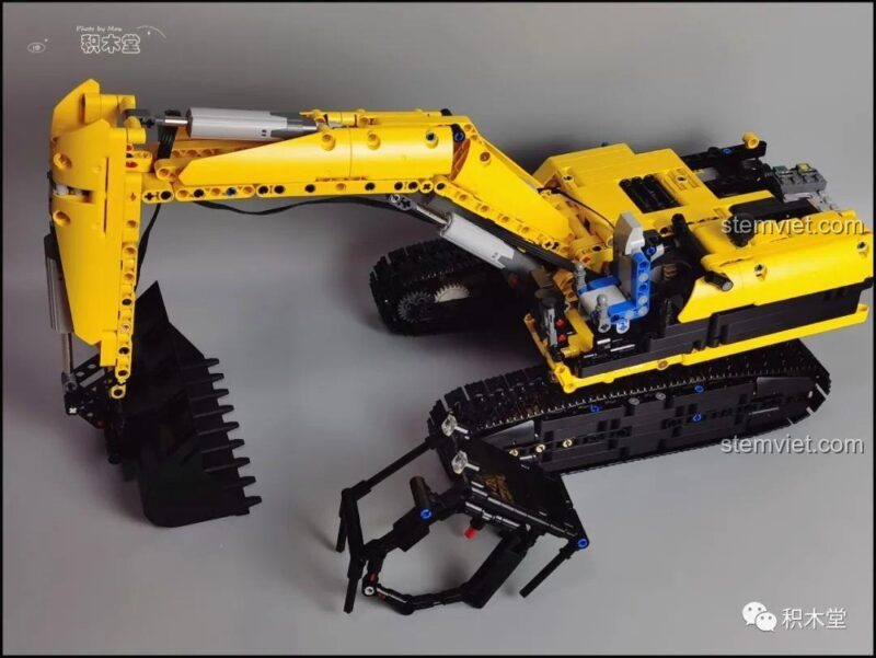 Góc nhìn bên hông của mô hình bộ đồ chơi Máy xúc Taigaole T4001 đang trong quá trình lắp ráp, cho thấy cấu trúc bên trong.