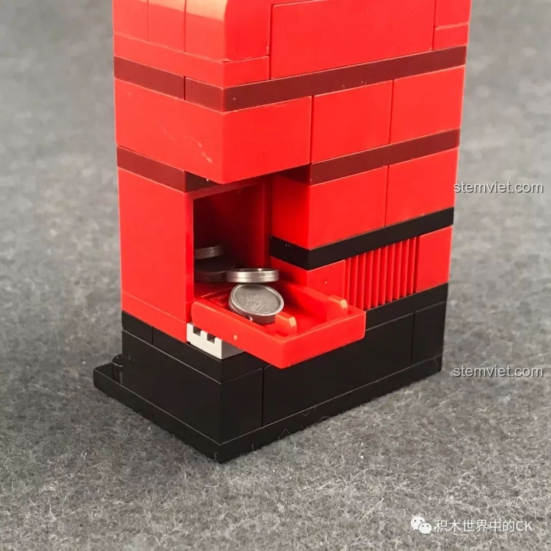 Khay chứa tiền xu của máy bán hàng tự động QMAN 1134, một tính năng tương tác thú vị cho trẻ.