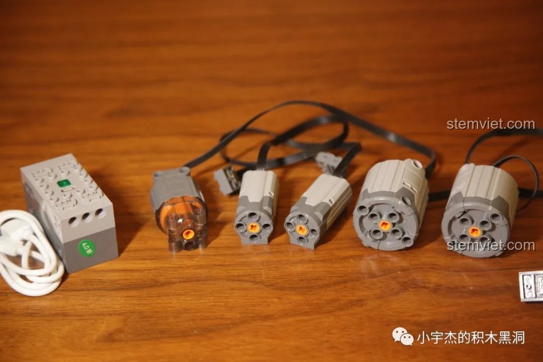 Toàn bộ hệ thống động cơ của Mould King 13122 sau khi mở hộp, bao gồm 5 motor, hộp pin và cáp sạc USB.