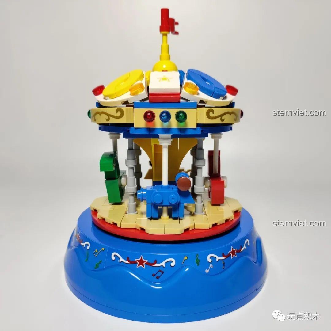 Tổng thể chiếc đu quay ngựa gỗ WOMA C0363 với các con thú nhiều màu sắc đang xoay tròn trên nền nhạc.