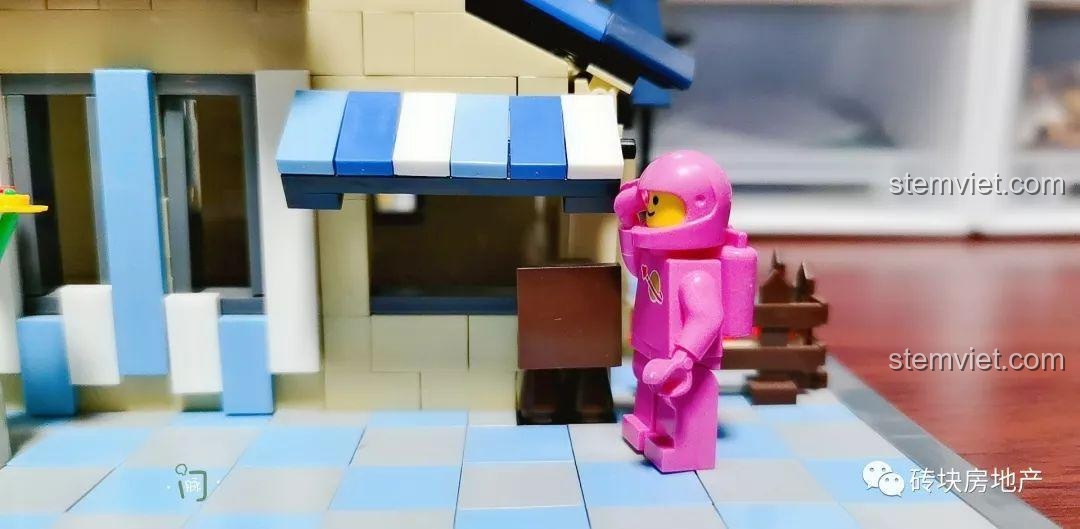 Cận cảnh mái hiên và cửa ra vào của Biệt Thự Đồng Quê Kiểu Pháp WANGE 5311, với nhân vật phi hành gia hồng đứng cạnh.