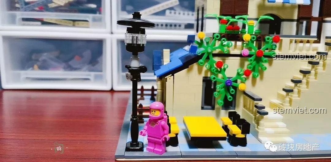 Khu vực sân bên ngoài Biệt Thự Đồng Quê Kiểu Pháp WANGE 5311, có bàn ghế và đèn đường, cùng nhân vật phi hành gia.