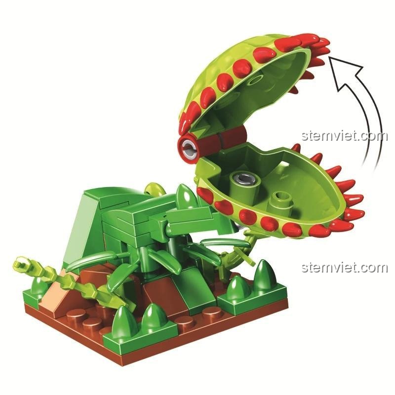 Mô hình cây ăn thịt màu xanh lá với khả năng đóng mở miệng, một phụ kiện độc đáo trong bộ đồ chơi Winner JEMLOU 8052 Xe Tải Bắt Khủng Long. Đồ chơi sáng tạo cho bé trai.