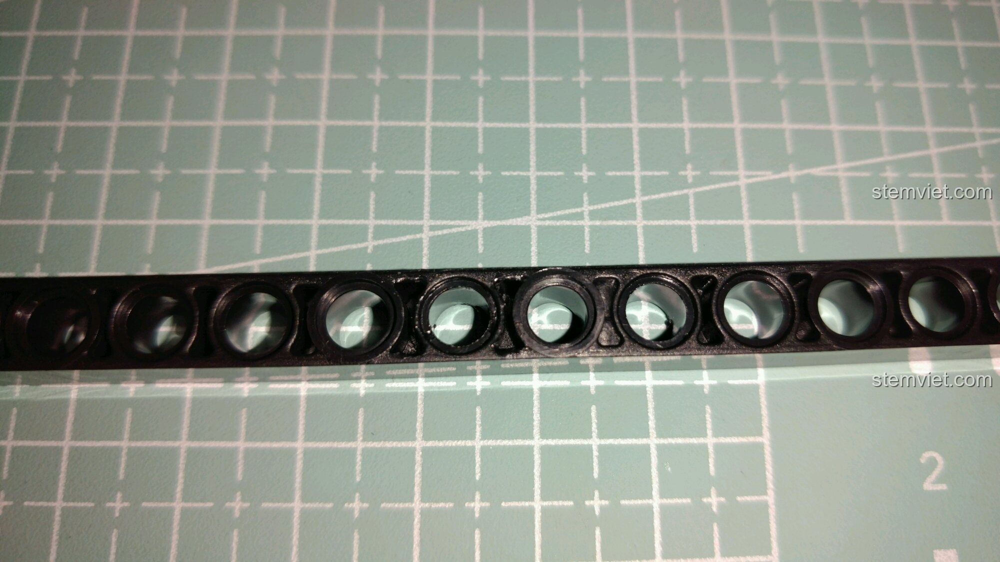 Cận cảnh các lỗ trên thanh dầm đen của bộ lắp ráp Xe Ba Bánh Cổ Điển Morgan 7065.