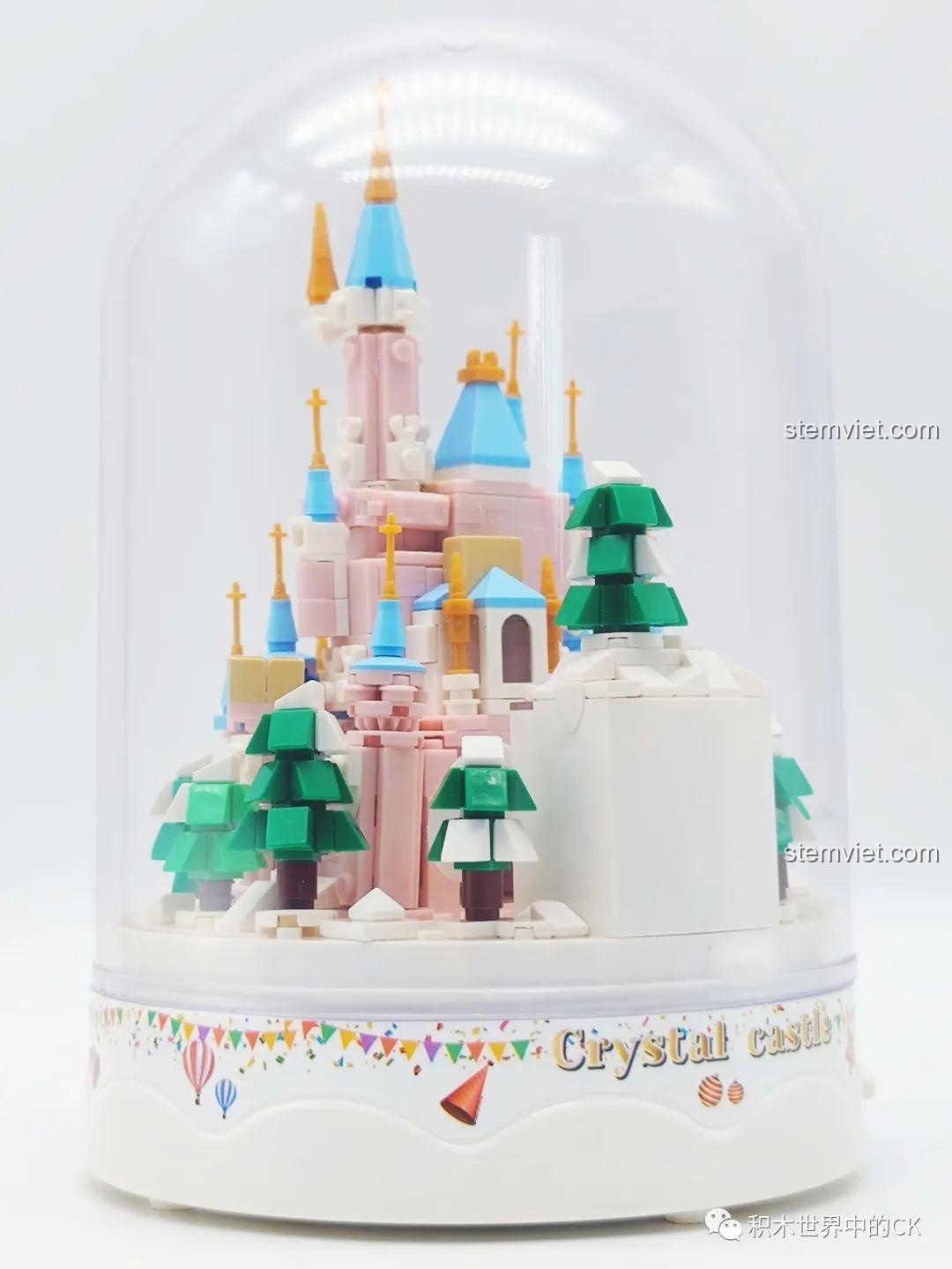 Cận cảnh phần đế và cây xanh của mô hình ZHEGAO 01043 Lâu đài Pha Lê trong vòm kính, thể hiện sự tỉ mỉ.