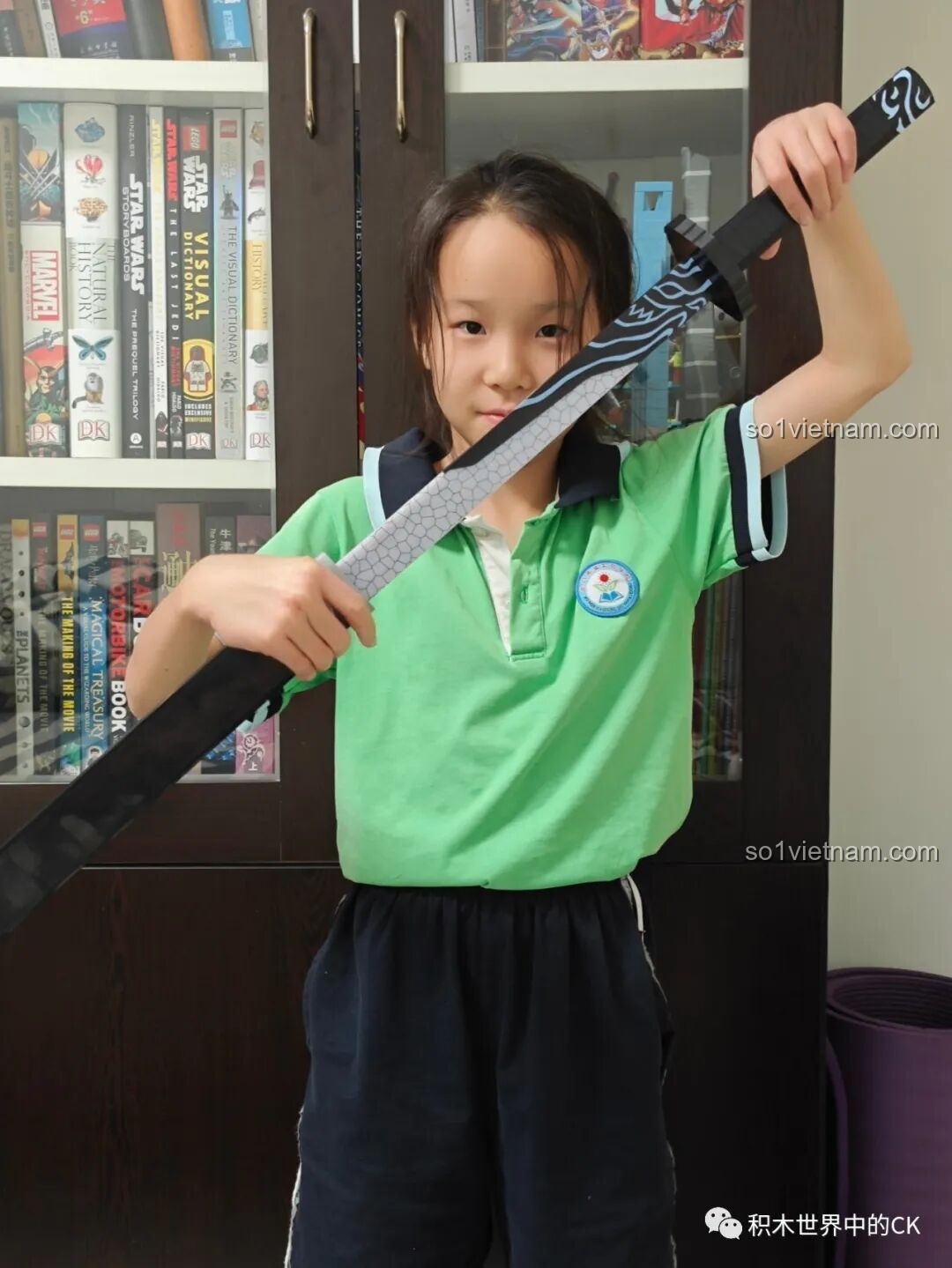 Một bé gái cầm thanh kiếm Ma Đao Thiên Nhận Balody 21108, thể hiện sự thích thú và phù hợp với trẻ em.