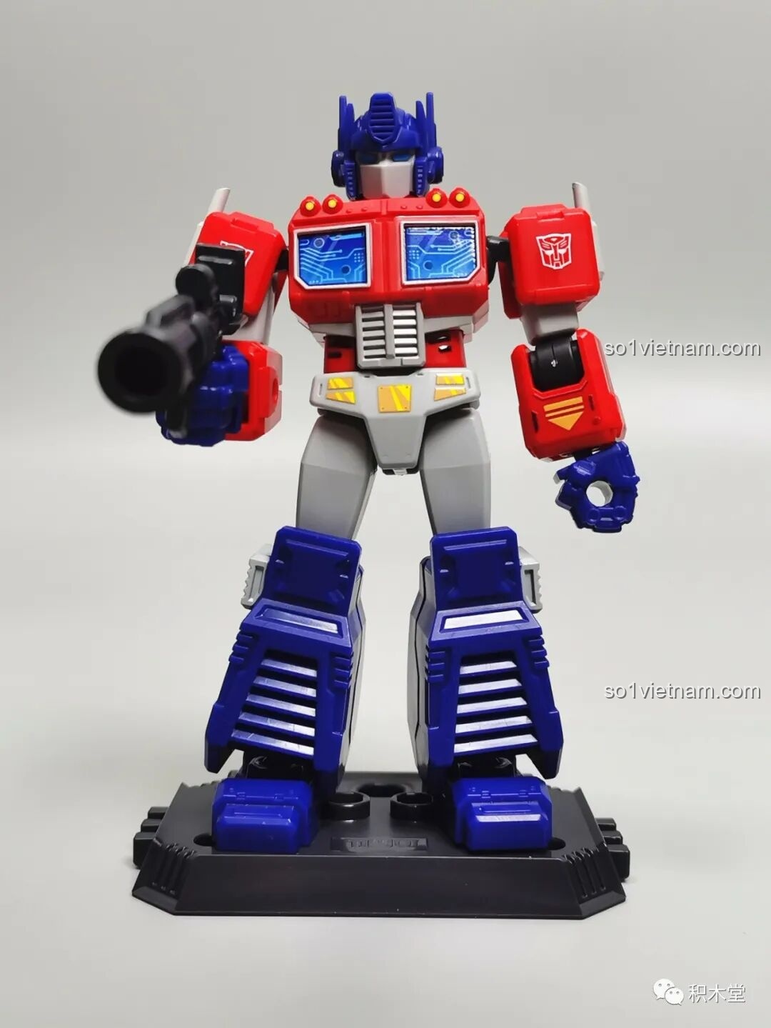 Figure Optimus Prime từ bộ BLOKEES 71100 sau khi lắp ráp hoàn chỉnh, đứng oai vệ trên đế trưng bày và cầm súng laser.
