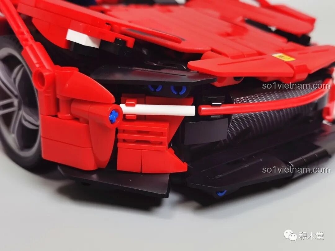 Cận cảnh phần cản trước và cụm đèn pha của mô hình Xe đua thể thao FP3, thiết kế góc cạnh và hầm hố.