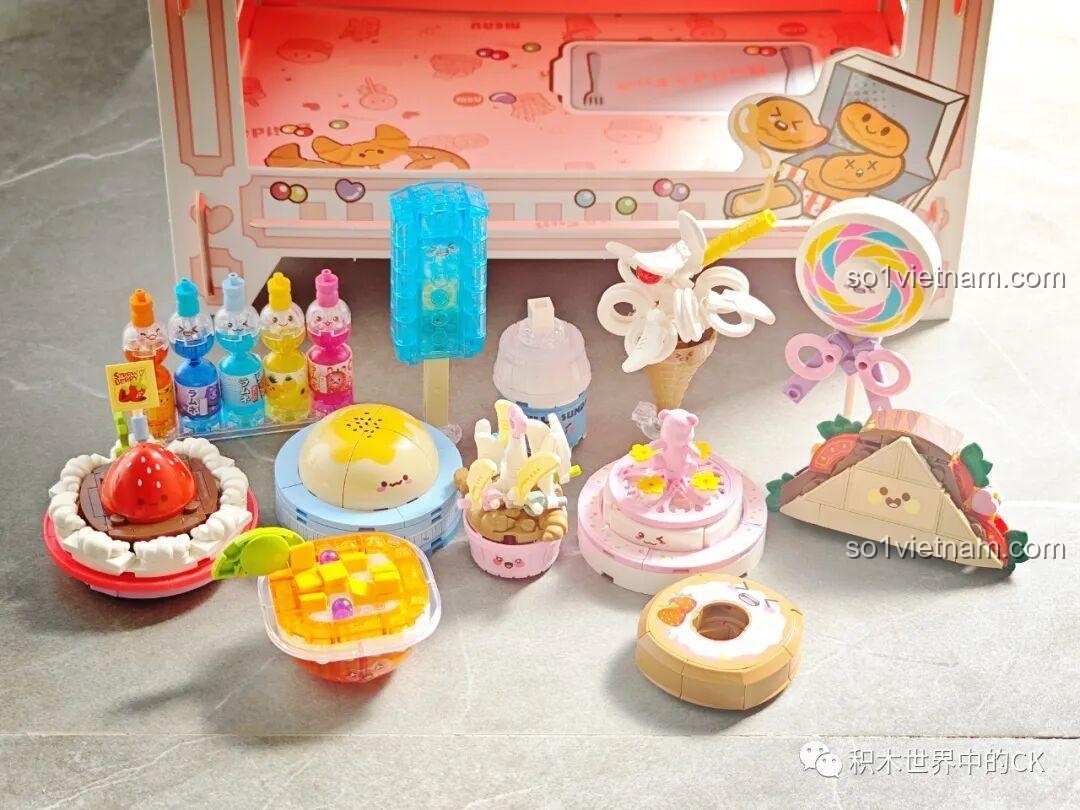 Cận cảnh các mô hình đồ ngọt từ bộ QMAN 35018 như kem, bánh ngọt, kẹo mút, bánh donut với chi tiết sắc sảo.