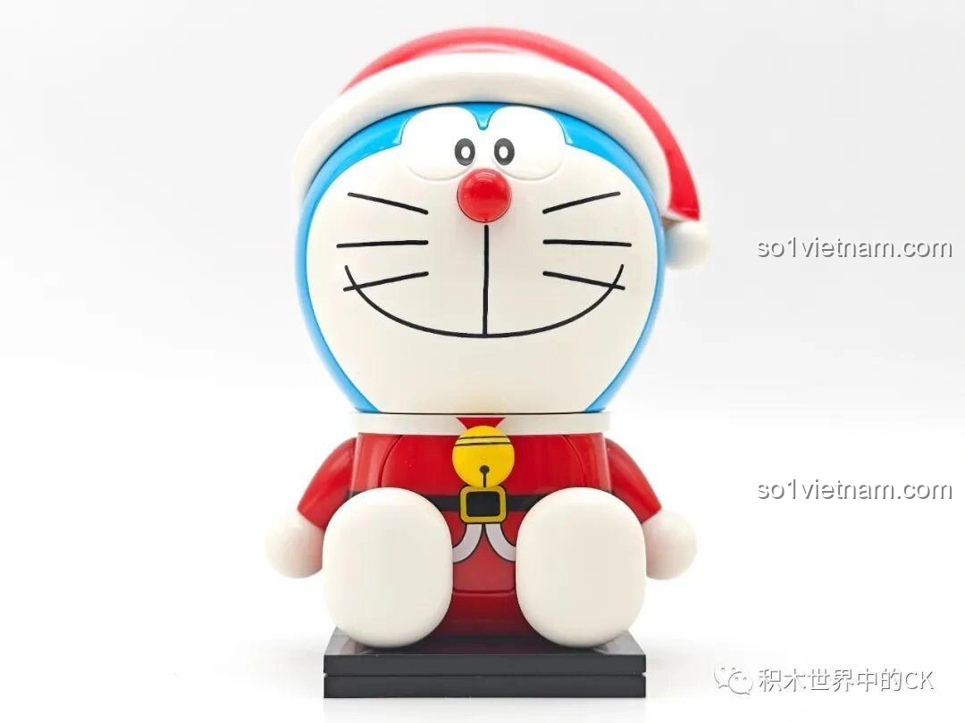 Cận cảnh mặt trước của Doraemon Giáng Sinh K20414, tập trung vào nụ cười, mũi đỏ và chiếc chuông vàng, cho thấy sự tỉ mỉ trong thiết kế figure Keeppley.
