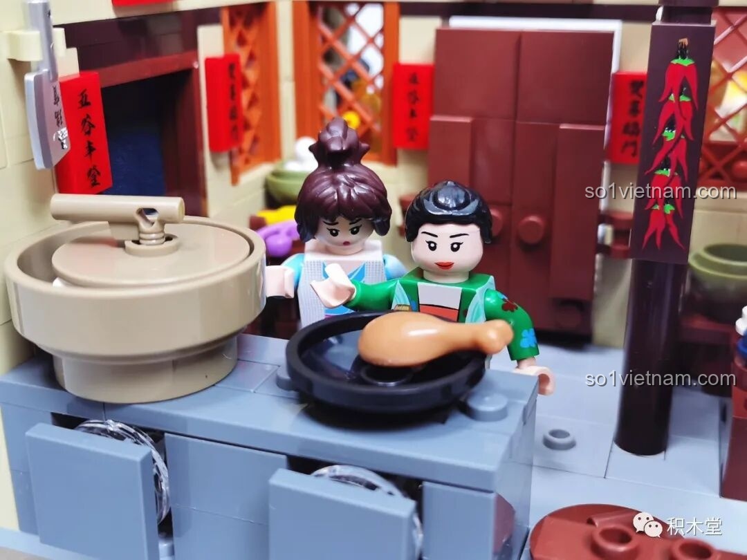 Cận cảnh hai minifigures đang nấu ăn trong nhà bếp với cối xay và bếp lò.