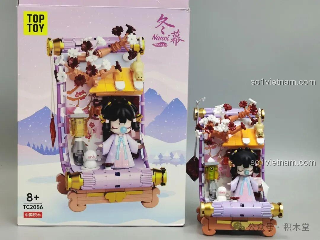 Mô hình Nanci mùa Đông TC2056 được đặt cạnh hộp sản phẩm, thể hiện vẻ đẹp lãng mạn và cổ tích của mô hình.