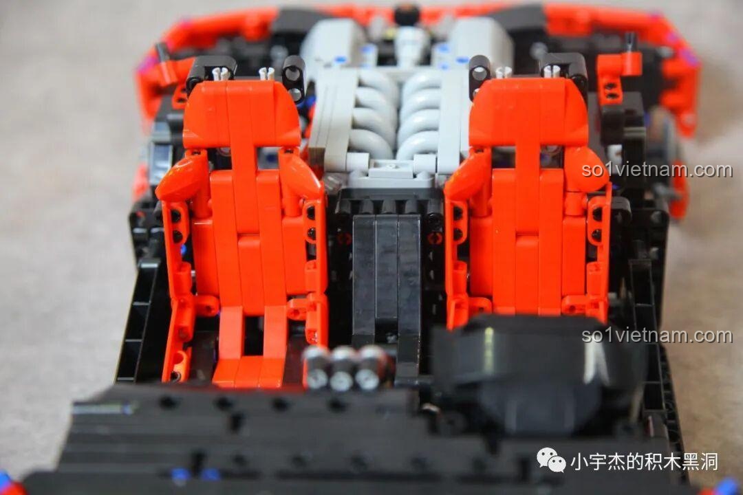 Hai chiếc ghế đua màu đỏ đã được lắp vào khoang lái của xe CBOX X001, nằm ngay phía trước khối động cơ V8 màu xám.