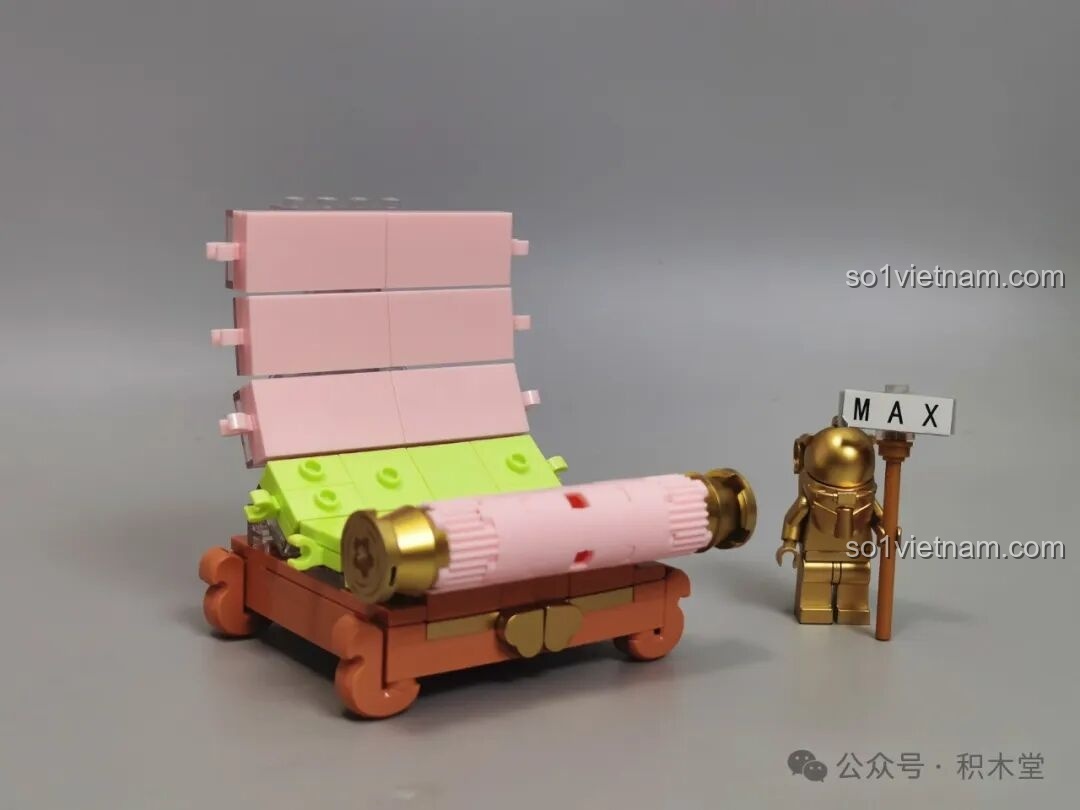 Quá trình lắp ráp phần đế và cuộn tranh của bộ TOP TOY Nanci mùa Xuân với các chi tiết màu hồng và xanh lá.