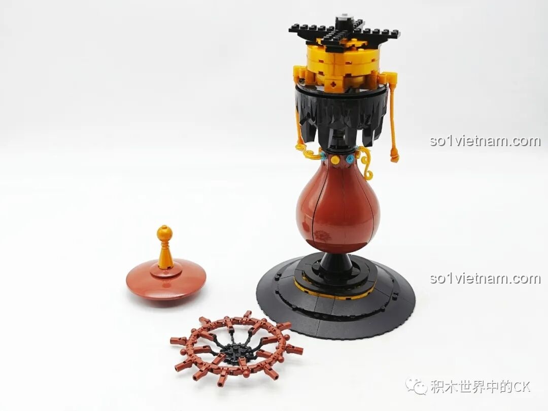 Tiếp tục lắp ráp phần thân đèn của bộ Đèn Bàn Cổ Điển ZHEGAO 00398, thêm các chi tiết nhỏ màu vàng và xanh ngọc tạo điểm nhấn.