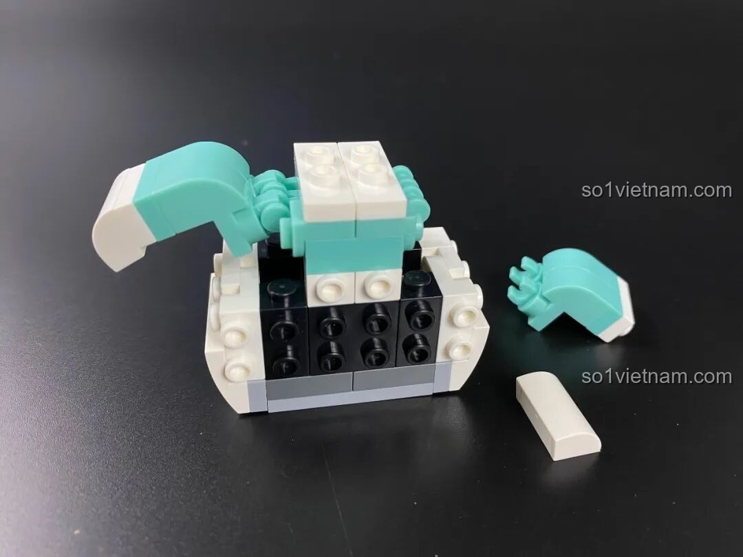 Lắp ráp phần thân của Pochacco KUPPY, với các mảnh ghép màu xanh mint và đen tạo thành cấu trúc bên trong.