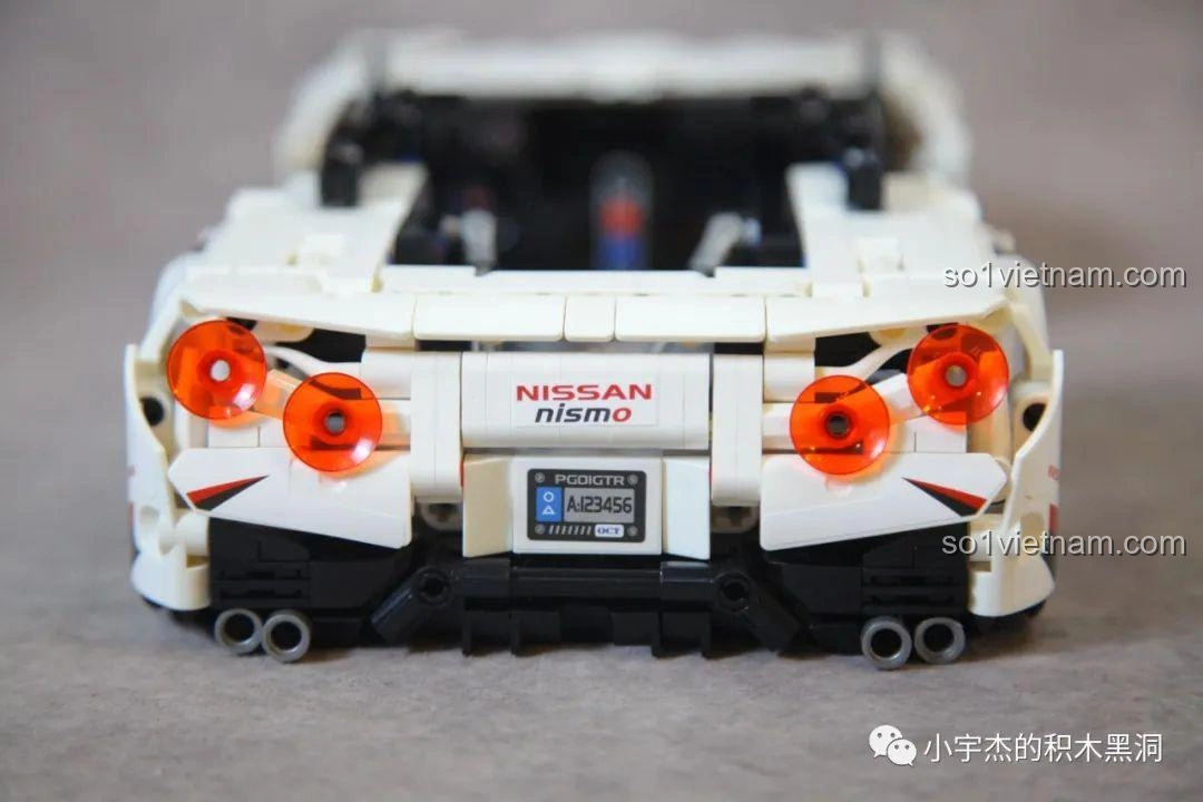 Cận cảnh đèn hậu tròn màu cam và biển số xe của mô hình Mei Ji 8622A Nissan GT-R, chi tiết sắc nét và độ hoàn thiện cao.