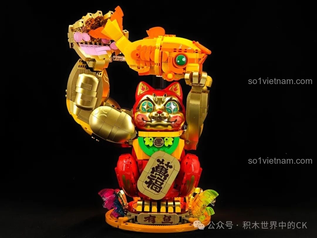 Thành phẩm bộ lắp ráp Mèo Chiêu Tài TOP TOY TC1830 với cánh tay vàng giơ cao ôm cá chép, màu sắc đỏ và vàng kim loại nổi bật
