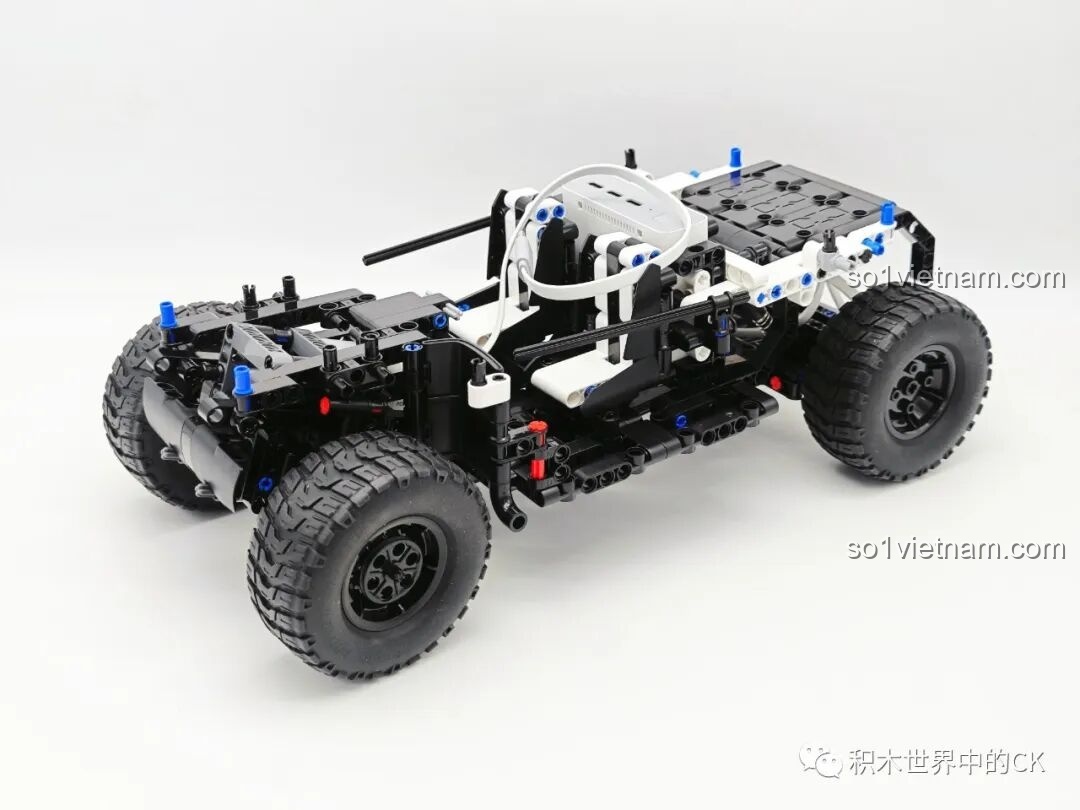 Khung gầm cơ bản của chiếc ONEBOT OBCPRC01AIQI Xe Tải Đua Địa Hình đang trong quá trình lắp ráp, thể hiện cấu trúc chắc chắn.