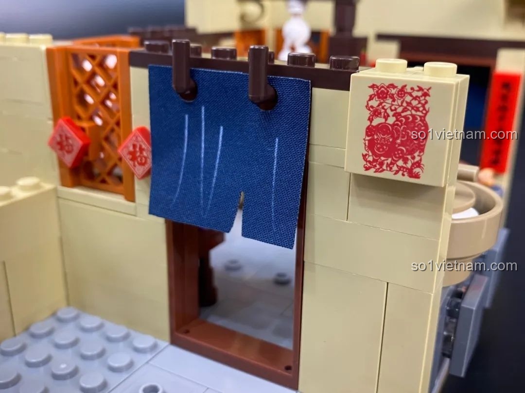 Chi tiết rèm cửa bằng vải và tranh giấy dán tường trong khu vực nhà bếp.