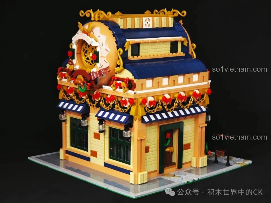 Tổng quan mặt bên trái của mô hình BAKA 33202 Xưởng Bánh Donut, với cửa ra vào và vòng hoa trang trí.