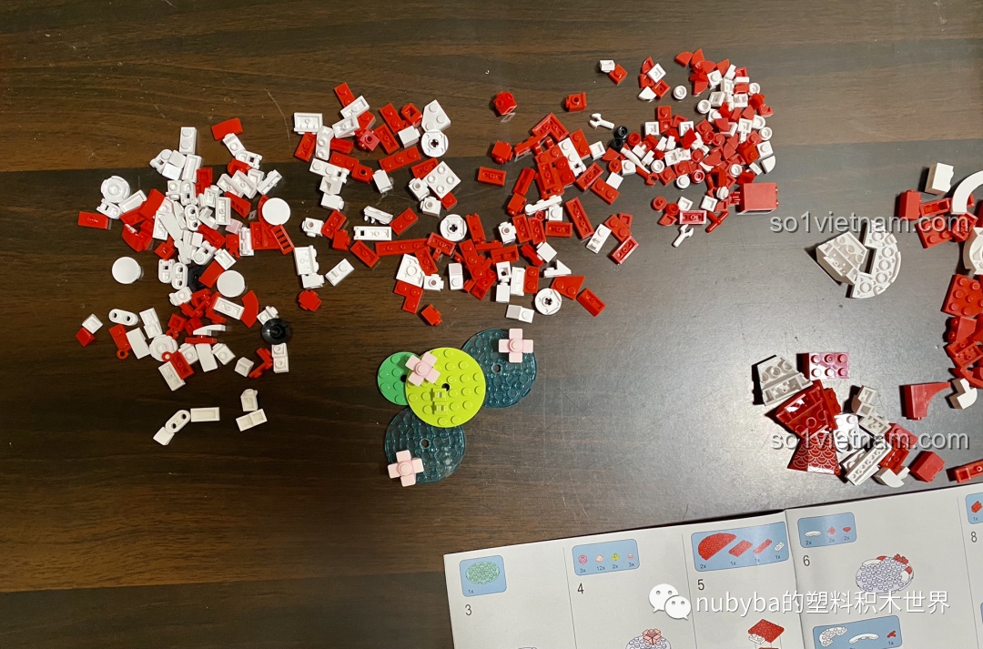 Đổ các mảnh ghép đồ chơi Cá Chép May Mắn JAKI JK20236 ra bàn, chuẩn bị cho quá trình lắp ráp.