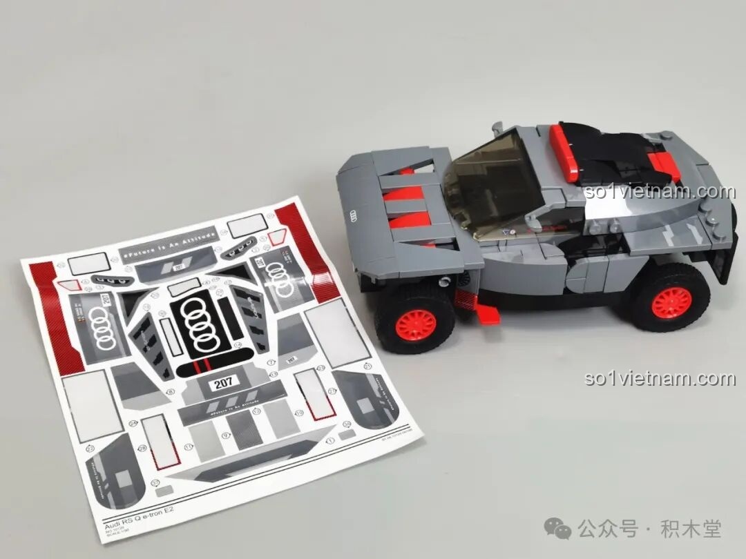 Mô hình RASTAR 10120 Audi RS Q e-tron E2 đã được lắp ráp gần hoàn chỉnh, đặt cạnh tấm sticker lớn, sẵn sàng cho bước trang trí cuối cùng.