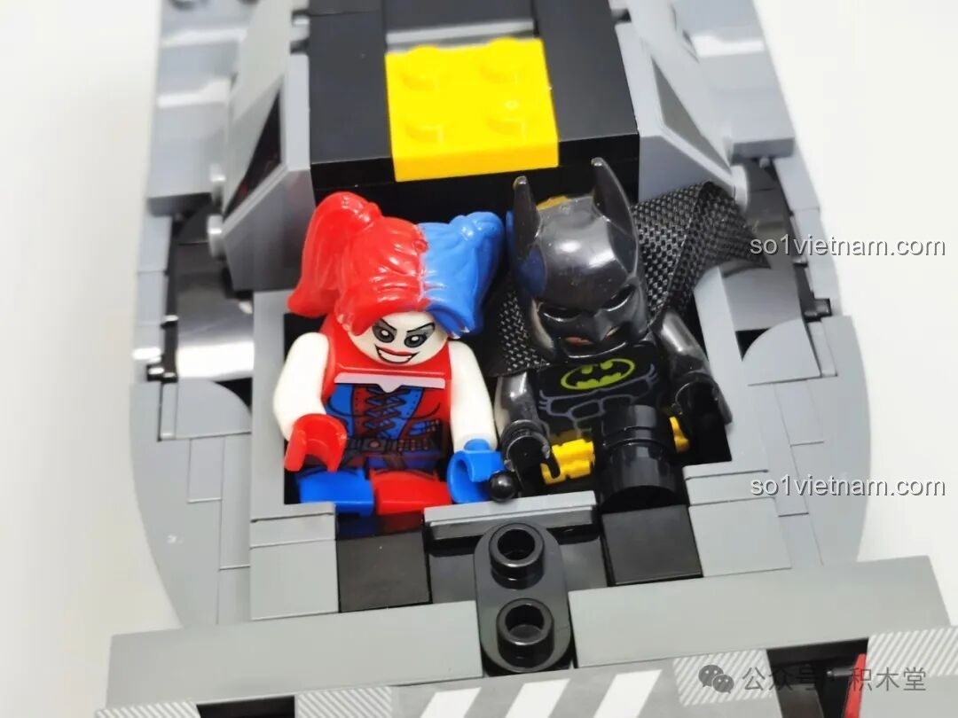Hai minifigures (Batman và Harley Quinn) được đặt trong khoang lái của mô hình RASTAR 10120 Audi RS Q e-tron E2, thể hiện khả năng chứa 2 người.