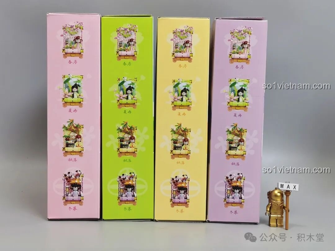 Cạnh bên của bốn hộp đồ chơi lắp ráp TOP TOY Nanci Cuộn Tranh Bốn Mùa xếp thẳng hàng.